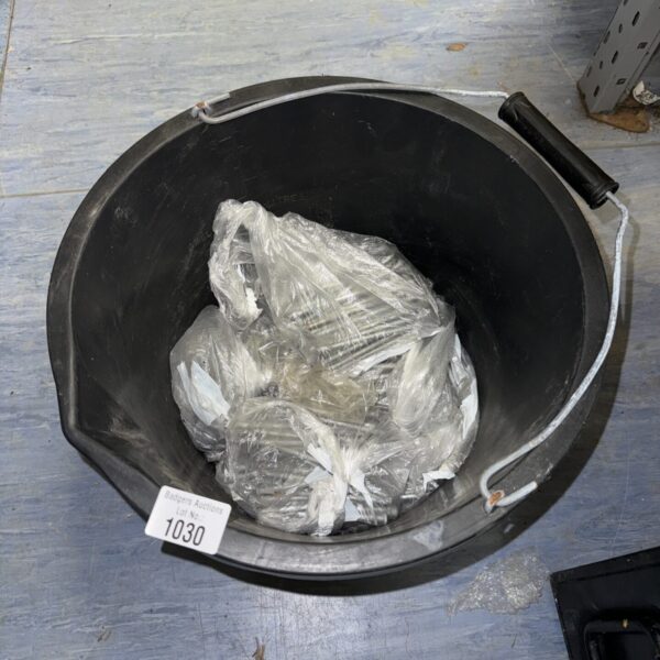 Bucket filled with assorted sized metal nails for DIY projects.