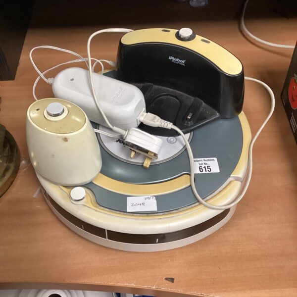 Irobot Roomba vacuum cleaner with charging dock, automated floor cleaning.