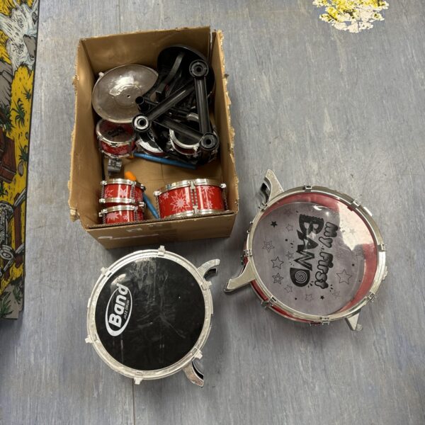 Colourful vintage children’s drum set with various drums and cymbals.