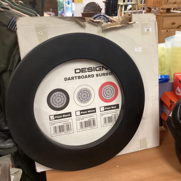 Black Designa dartboard surround for wall protection during darts games.