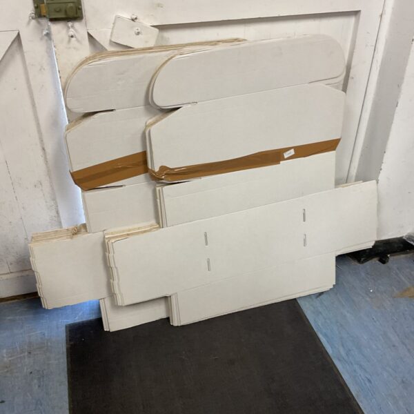 Stack of white cardboard storage boxes for moving or storage.