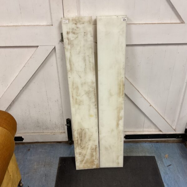 Two solid engineering nylon blocks for industrial use.