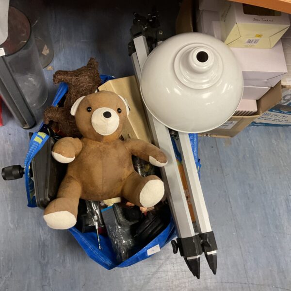 Mixed house clearance lot with tripod, headphones, and teddy bear.
