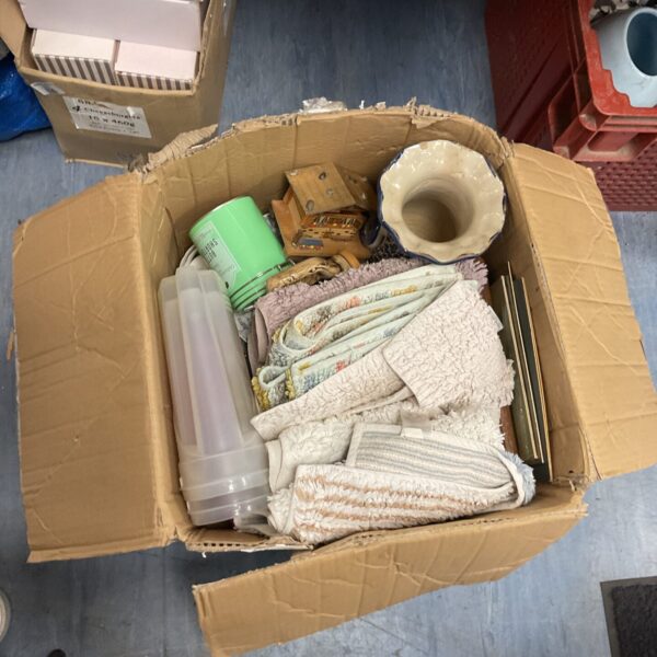 House clearance lot with bathroom mats, Tupperware and vases.