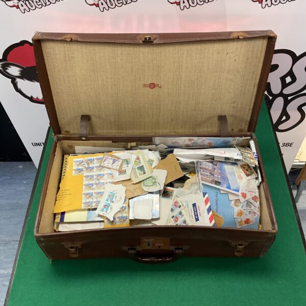 Vintage leather suitcase filled with a world stamp collection.