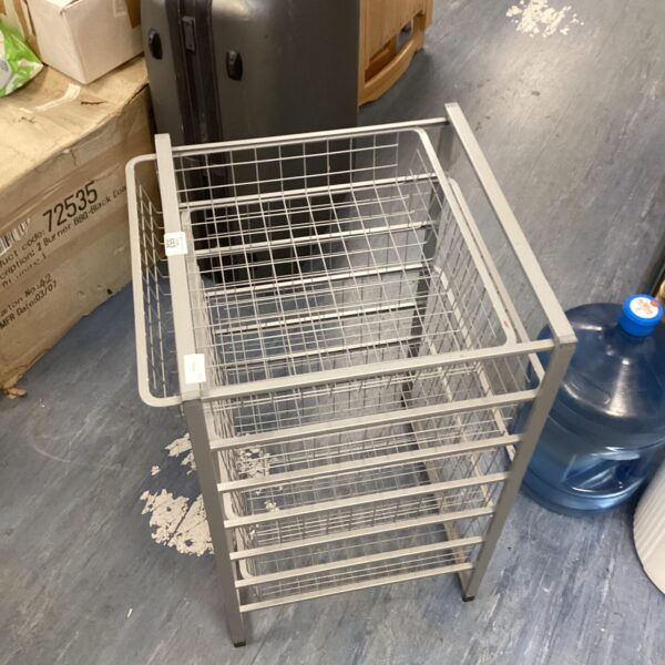 Metal desk tidy with four wire baskets for office organisation.