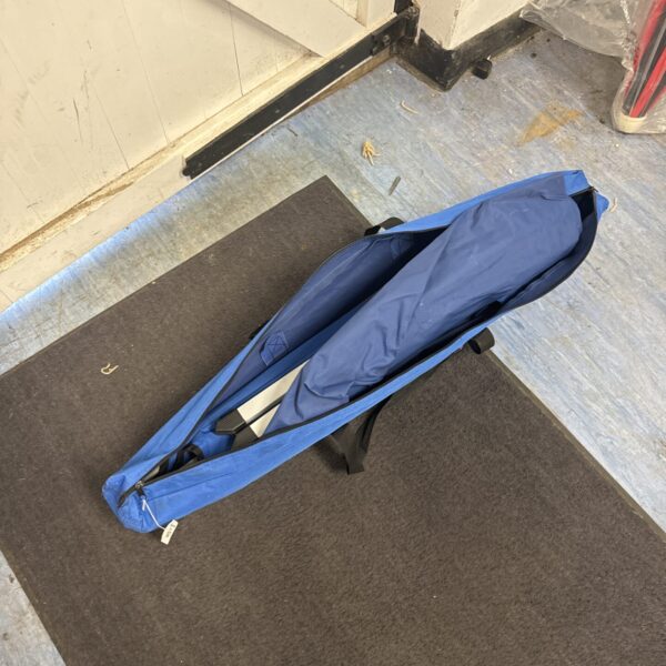 Closed folding camping bed showing fabric and frame.