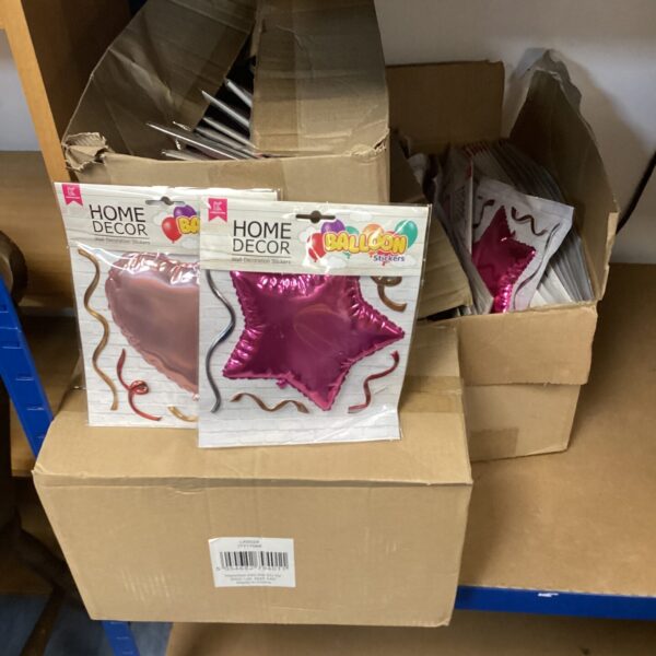 Four boxes of celebration foil balloons for parties and events.