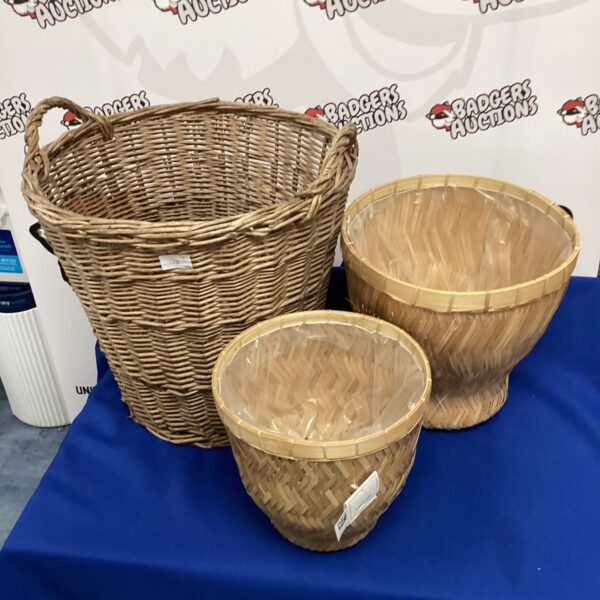 Set of three woven wicker baskets for storage.