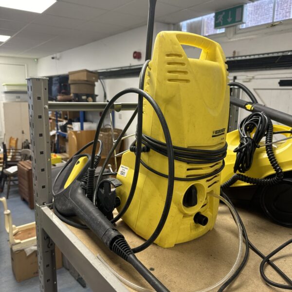 Yellow Karcher K2.29 pressure washer with hose and handle.