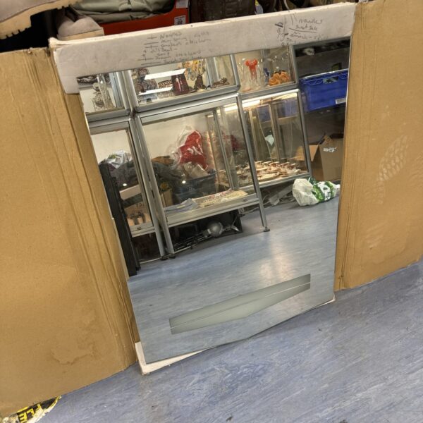 Front view of a large illuminated bathroom mirror with lights.