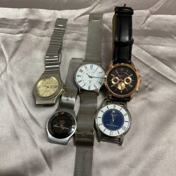Assorted vintage and modern wristwatches on a display tray.