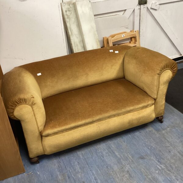 Gold antique Chesterman sofa with drop down arm.