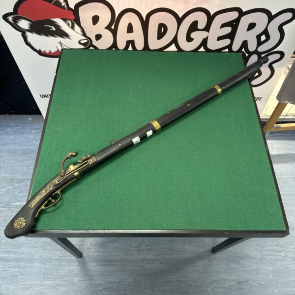 Detailed decorative musket replica for wall display.