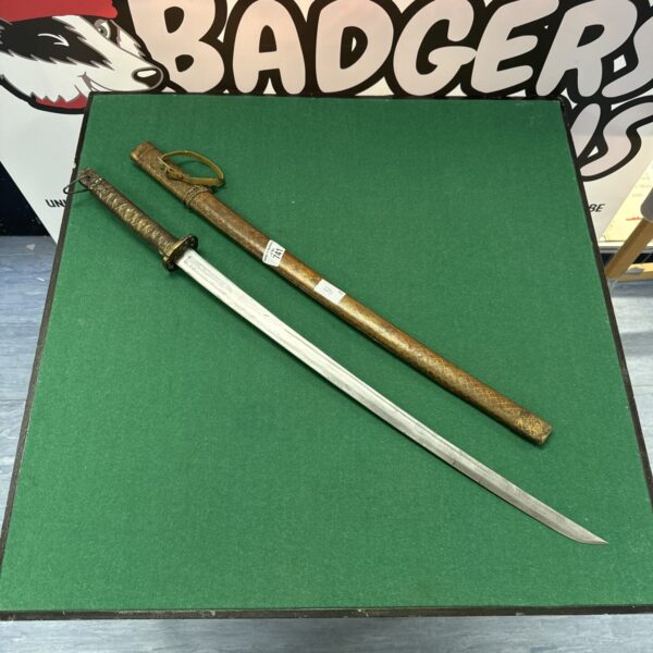 Vintage decorative samurai sword with wooden scabbard.