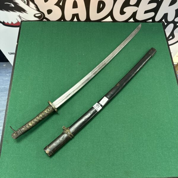 Vintage decorative samurai sword with detailed handle and curved blade.