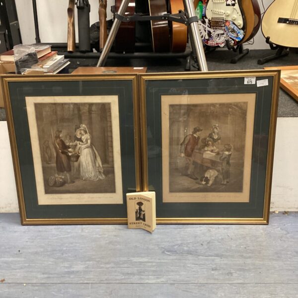 Antique framed Cries of London prints displayed with a book.