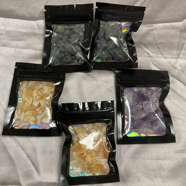 Sealed bag of amethyst tumbled crystals for collection.