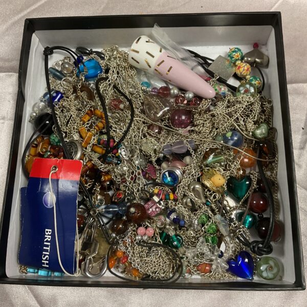 Assorted costume jewellery tray with necklaces, brooches and beads.