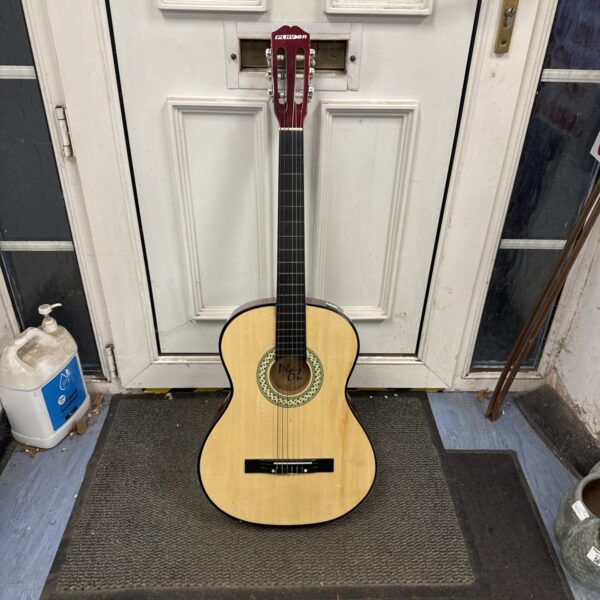 Classical acoustic guitar with nylon strings, ideal for learning music.