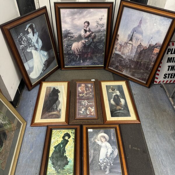 Collection of vintage framed prints for wall decor.