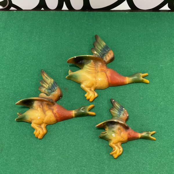 Set of three vintage cast aluminium ducks for wall display.