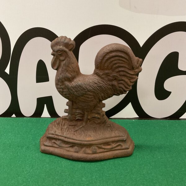 Antique cast iron cockerel doorstop with detailed feathering.