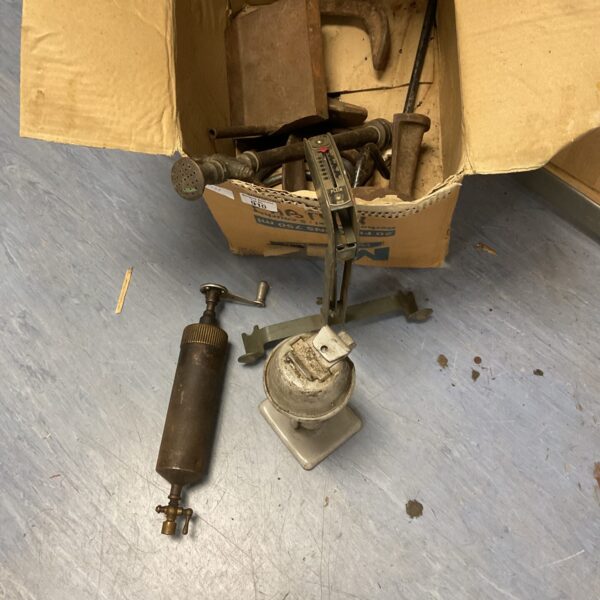 Antique hydraulic grease gun and belt tension gauge, vintage tools.