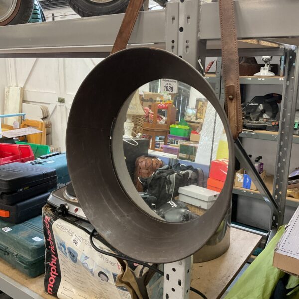 Round man cave mirror with leather strap detail.