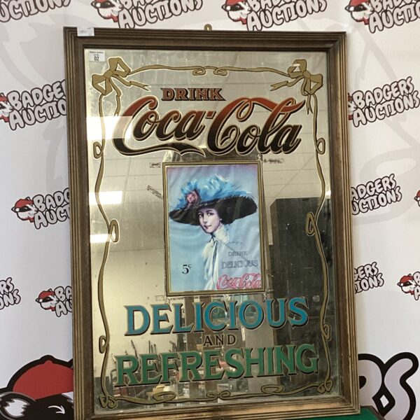 Large vintage Coca-Cola mirror with ornate frame.