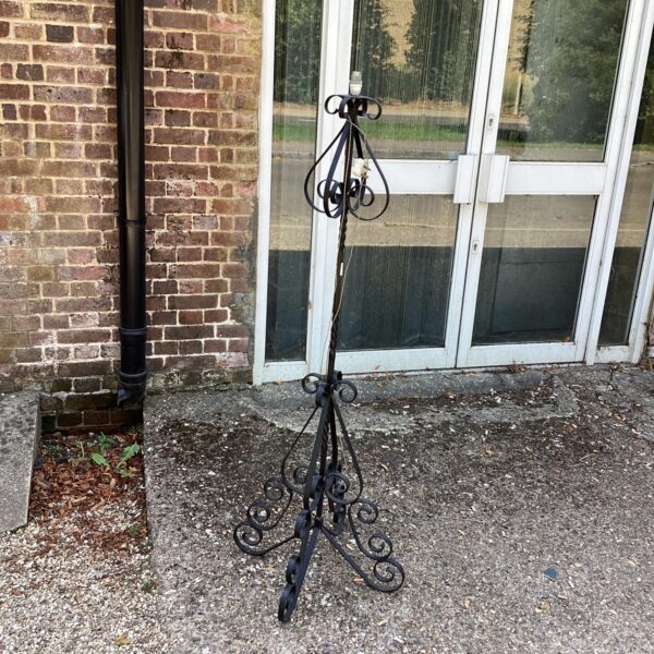 Ornate vintage decorative metal garden lamp with tripod base.