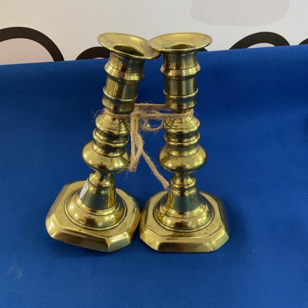 Pair of vintage brass candle sticks with octagonal bases.