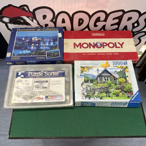 Puzzle and board game lot including jigsaw, sorter, and Monopoly.