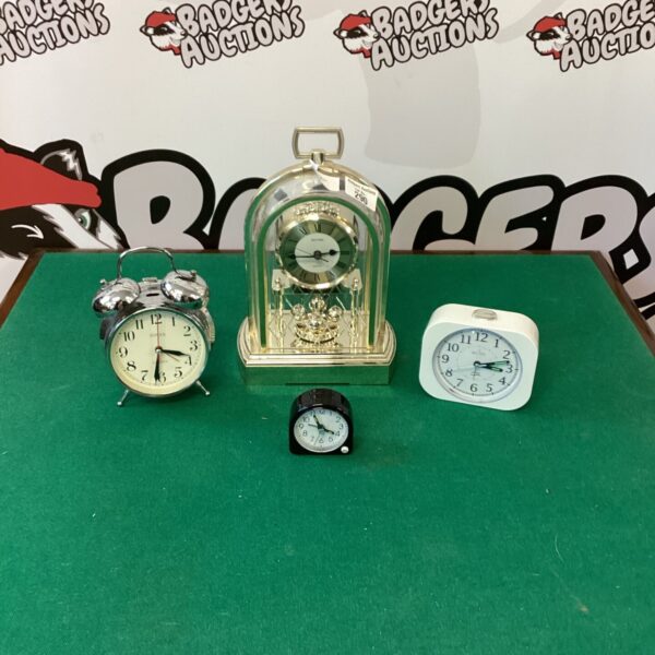 White dial vintage mantle clock on display.
