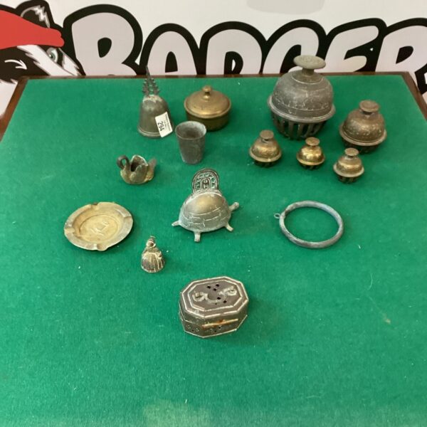 Antique Nepalese brass temple bells and brassware collection on display.