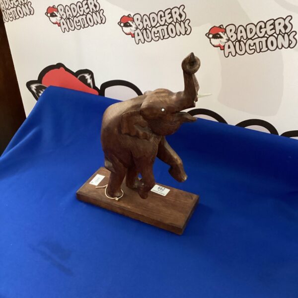 Detailed hand-carved wooden elephant figurine for home decor.