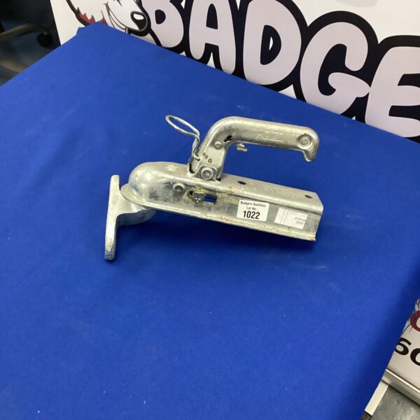 Close-up of tow bar hook with spring-loaded pin mechanism.