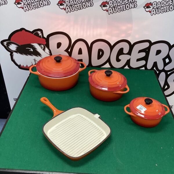 Vibrant orange La Potiere casserole dishes and griddle pan set.