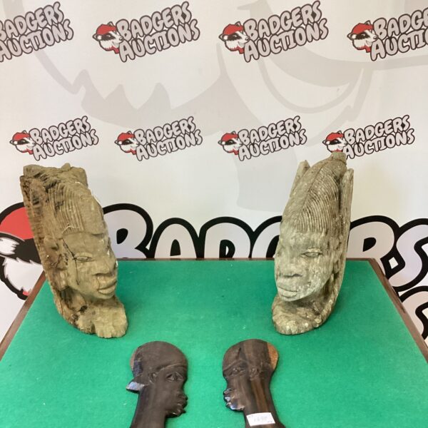 Antique African carved wood heads on vintage plaques, tribal art.