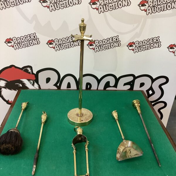 Antique brass fire companion set with ornate detailing and vintage patina.