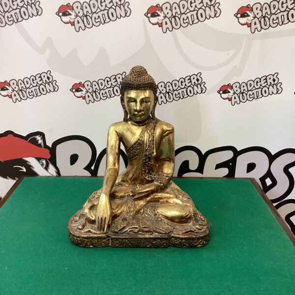Vintage gilded wood Buddha statue with serene expression.