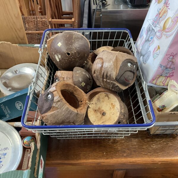 Lot of carved monkey head coconut vessels for tropical decor.