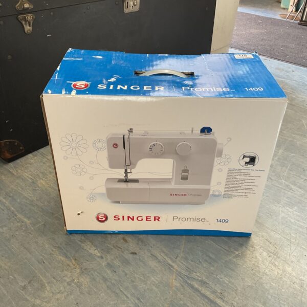 Vintage boxed Singer 1409 sewing machine in original packaging.
