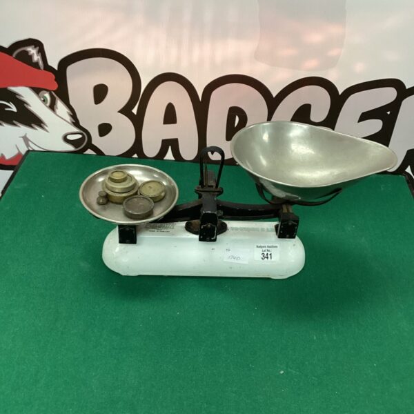 Vintage white Avery balance scales with weights for accurate measurement.