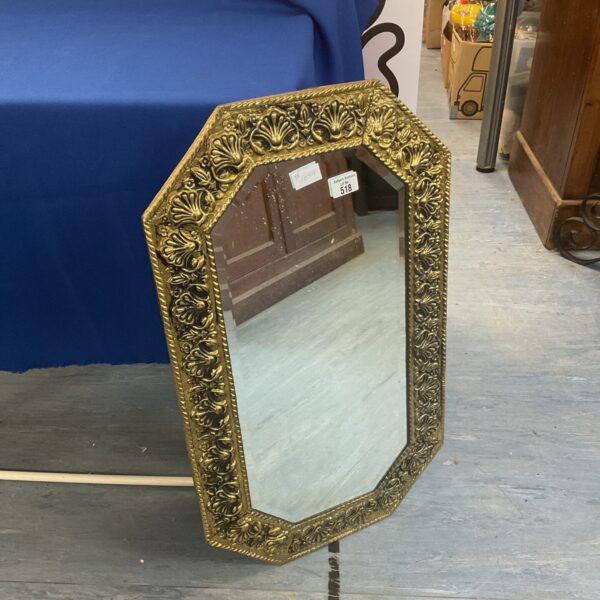 Ornate vintage brass framed mirror with bevelled edge.