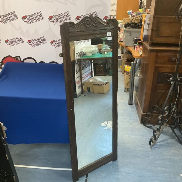 Antique oak mirror with carved scroll decoration, vintage wall decor.
