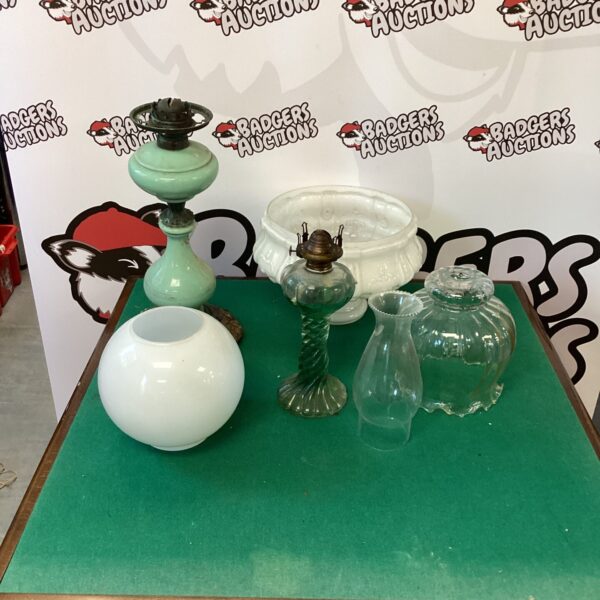 Selection of vintage oil lamps with glass shades.
