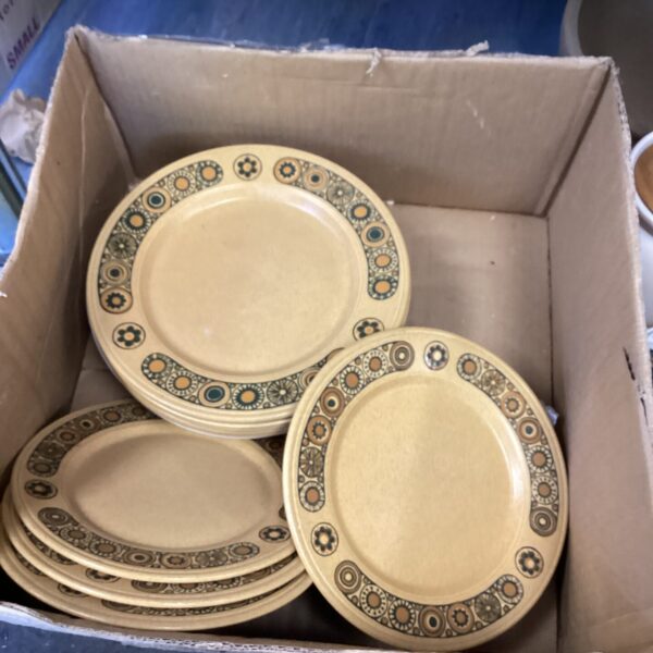 Vintage Kiln Craft plates with a 1970s geometric pattern.