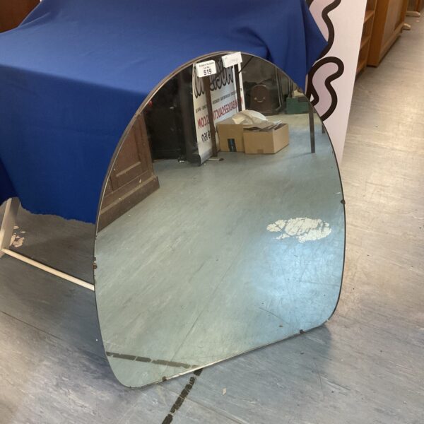 Vintage semi-oval wall mirror with a retro aesthetic.