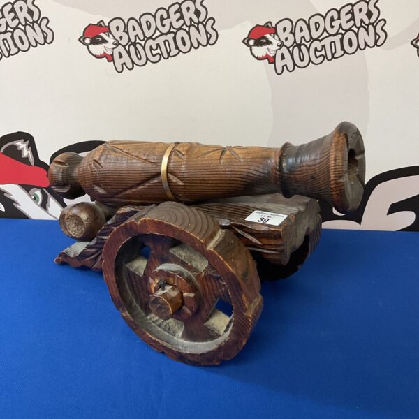 Detailed vintage wooden cannon, nautical decor collectible.